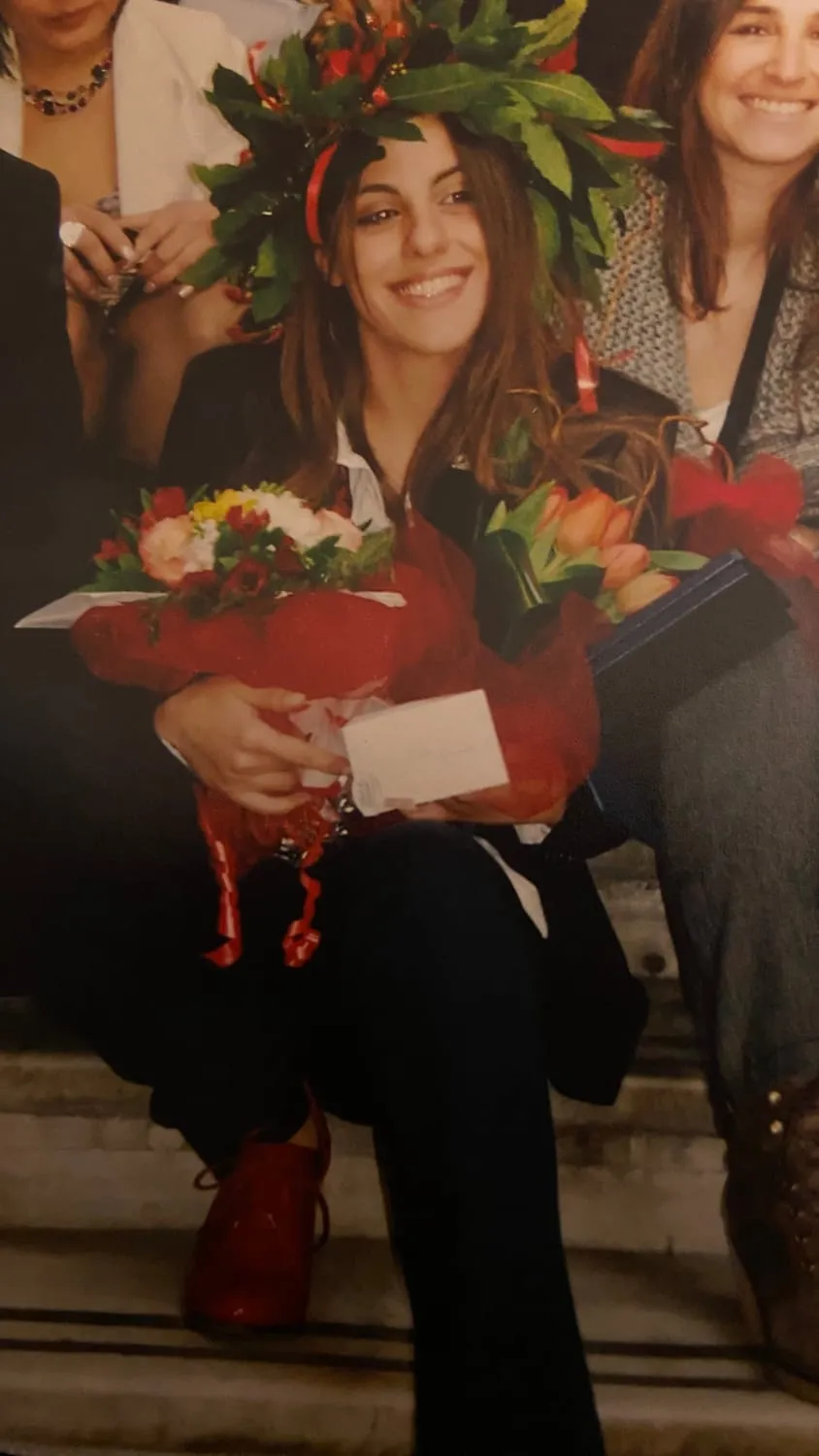Claudia on her law graduation day at the University of Genoa, wearing a laurel wreath